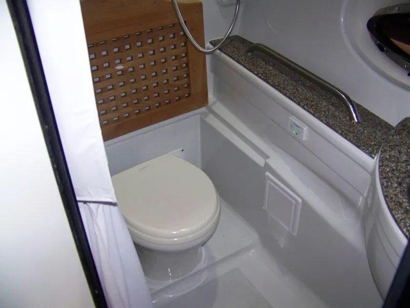 Slide: The Image of 2020 Crownline 350 SY yacht bathroom with toilet and granite countertop. - 29