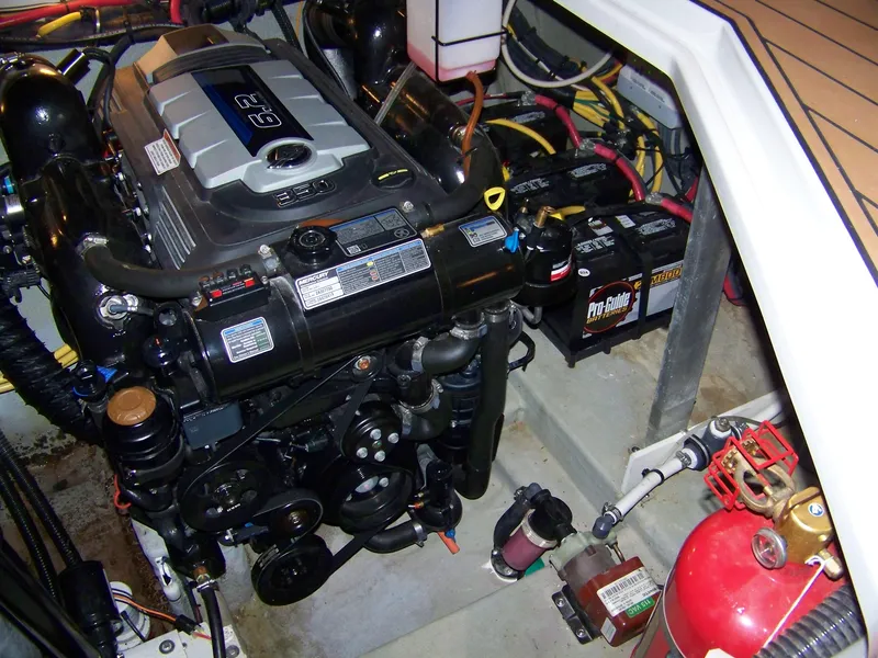 Slide: The Image of Engine compartment of a 2020 Crownline 350 SY boat, featuring a powerful engine and batteries. - 33