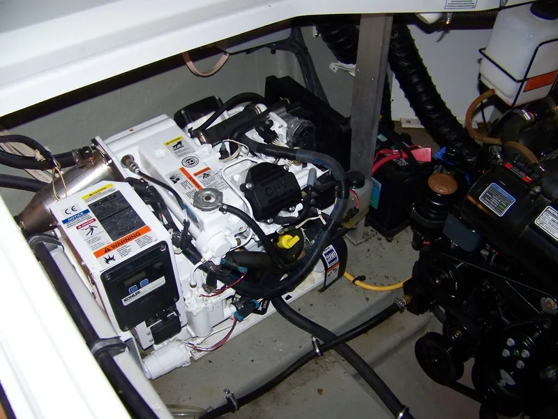 Slide: The Image of Engine compartment of 2020 Crownline 350 SY boat, showcasing mechanical components and wiring. - 34