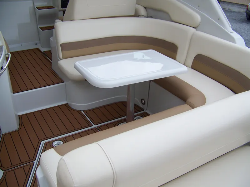 Slide: The Image of 2020 Crownline 350 SY boat interior with beige seating and wooden flooring. - 6