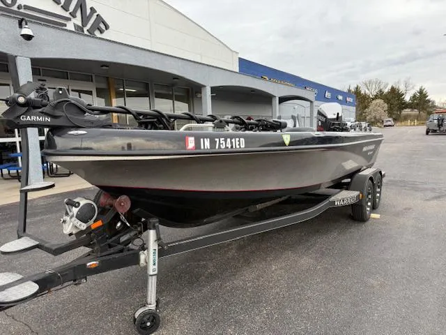 Slide: The Image of 2016 Warrior V2090 boat on trailer, parked outside a dealership. - 2
