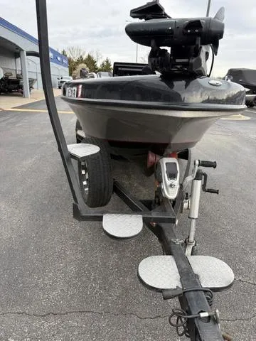 Slide: The Image of 2016 Warrior V2090 boat on trailer, parked outdoors, featuring a trolling motor. - 5