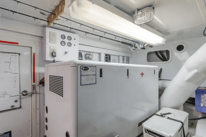 Slide: The Image of Engine room of 2005 Ocean Alexander 548 Pilothouse yacht, featuring generator and control panel. - 16