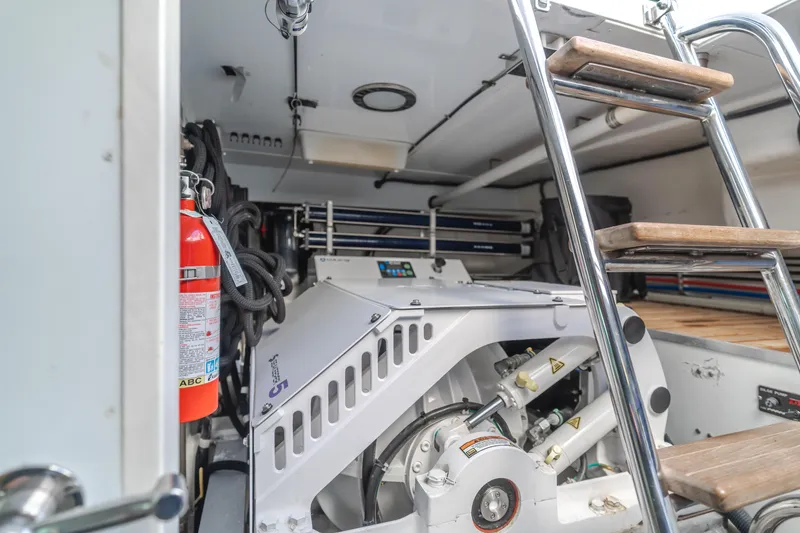 Slide: The Image of Engine room of 2005 Ocean Alexander 548 Pilothouse yacht with visible machinery and ladder. - 19