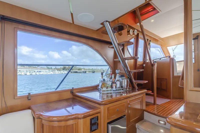 Slide: The Image of Interior of 2005 Ocean Alexander 548 Pilothouse yacht with bar and staircase, overlooking water. - 24