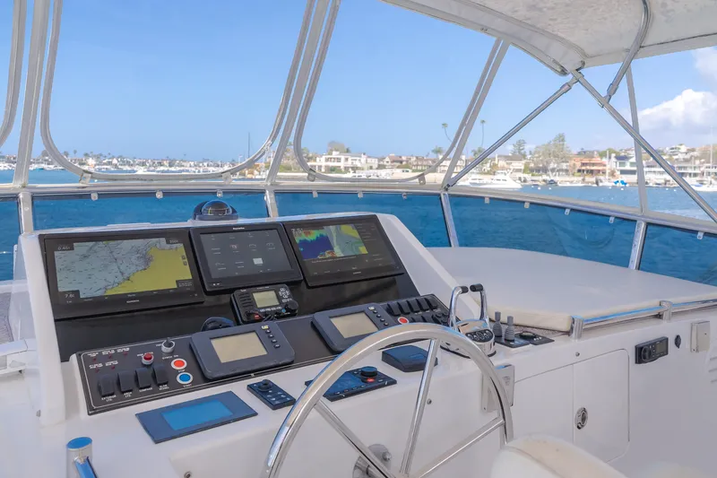 Slide: The Image of 2005 Ocean Alexander 548 Pilothouse helm with navigation screens, overlooking marina. - 34