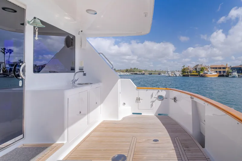 Slide: The Image of 2005 Ocean Alexander 548 Pilothouse yacht deck with sink, overlooking marina and blue sky. - 35