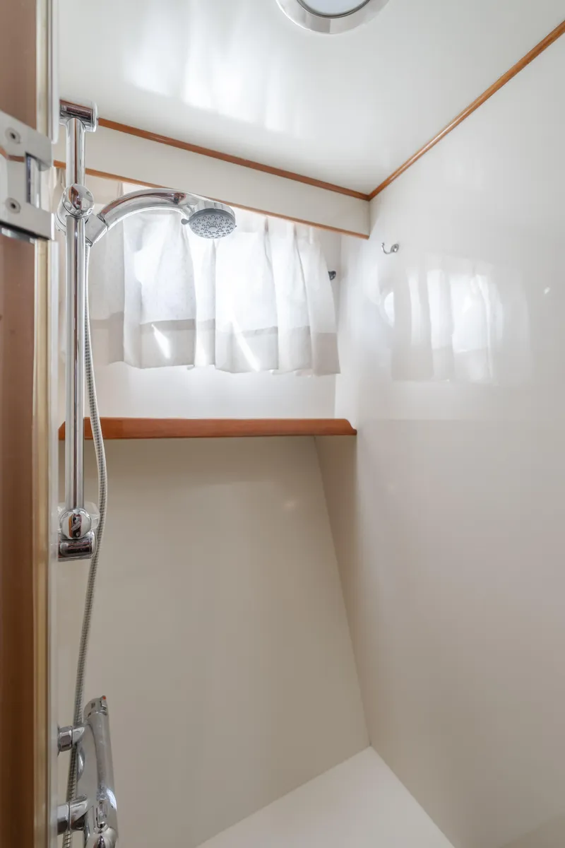 Slide: The Image of Shower area in 2005 Ocean Alexander 548 Pilothouse yacht with curtain and wooden accents. - 47