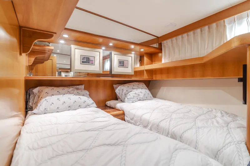 Slide: The Image of 2005 Ocean Alexander 548 Pilothouse cabin with twin beds and wooden interior. - 48