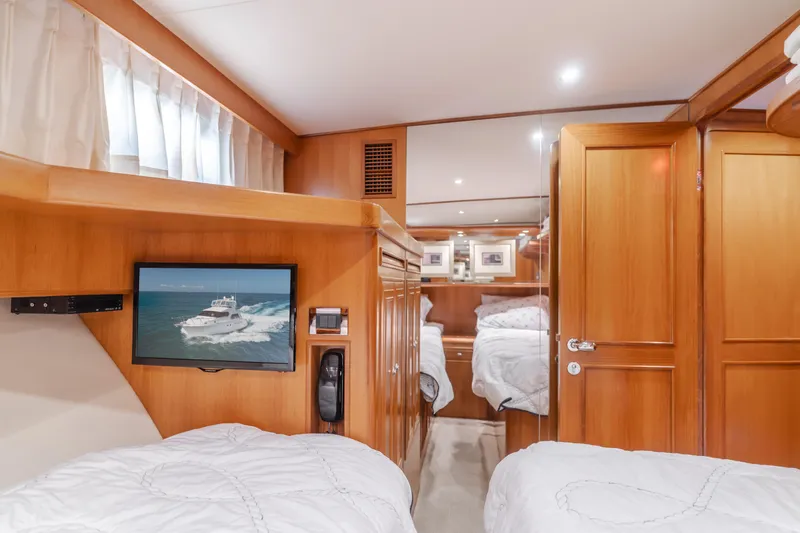 Slide: The Image of Luxurious 2005 Ocean Alexander 548 Pilothouse cabin with twin beds and wood paneling. - 49