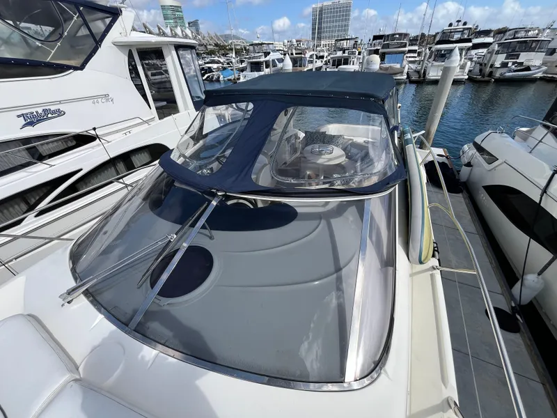 Slide: The Image of 2006 Azimut Atlantis yacht docked in marina, featuring sleek design and spacious deck. - 10