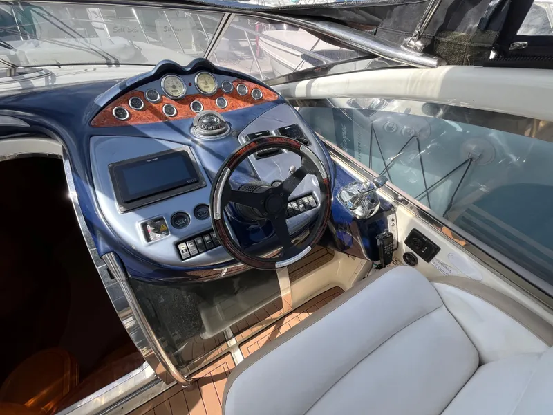 Slide: The Image of Helm of 2006 Azimut Atlantis yacht with modern controls and luxurious seating. - 14