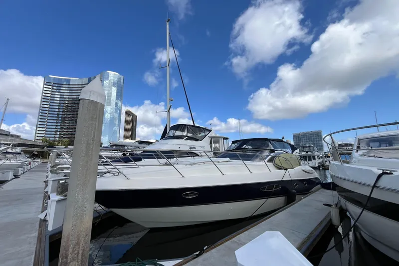 Slide: The Image of Azimut Atlantis 2006 yacht docked at marina with city skyline background. - 2