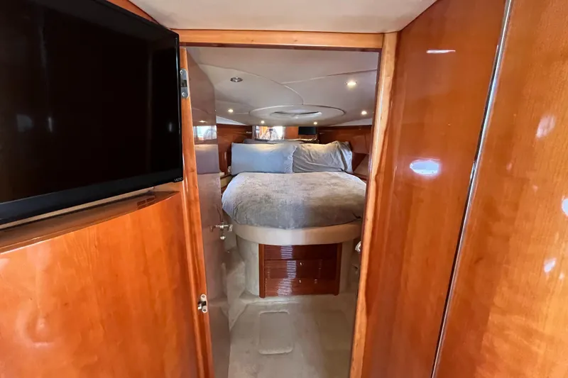 Slide: The Image of Luxurious 2006 Azimut Atlantis yacht bedroom with wood paneling and cozy bedding. - 28