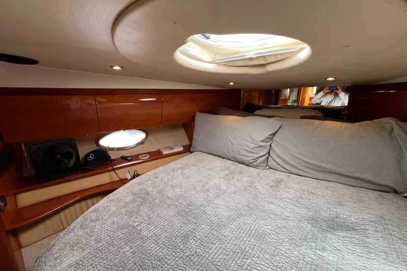 Slide: The Image of Luxurious cabin interior of a 2006 Azimut Atlantis yacht with cozy bedding and elegant wood finish. - 29