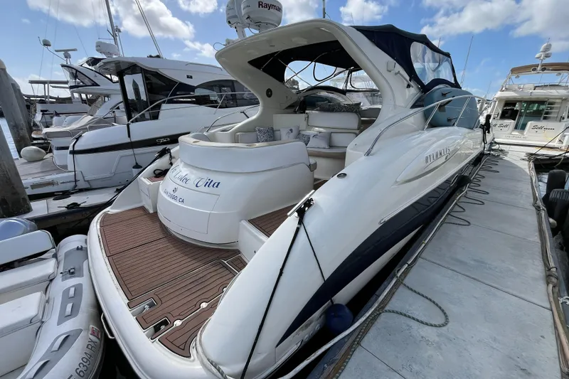 Slide: The Image of 2006 Azimut Atlantis yacht docked at marina, featuring sleek design and spacious deck. - 3