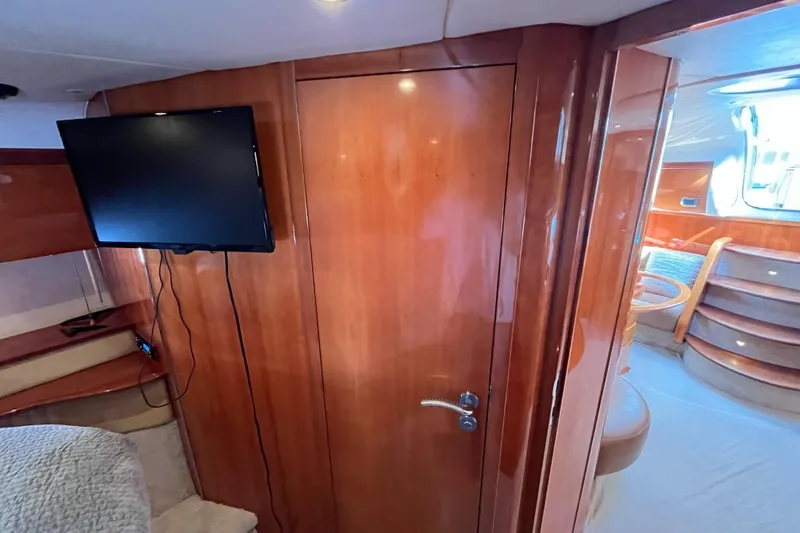 Slide: The Image of Interior of 2006 Azimut Atlantis yacht with wooden paneling and mounted TV. - 30