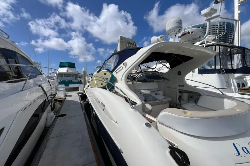 Slide: The Image of 2006 Azimut Atlantis yacht docked under a bright blue sky. - 4