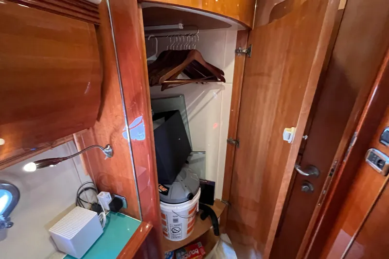 Slide: The Image of 2006 Azimut Atlantis yacht interior closet with wooden finish and storage items. - 40