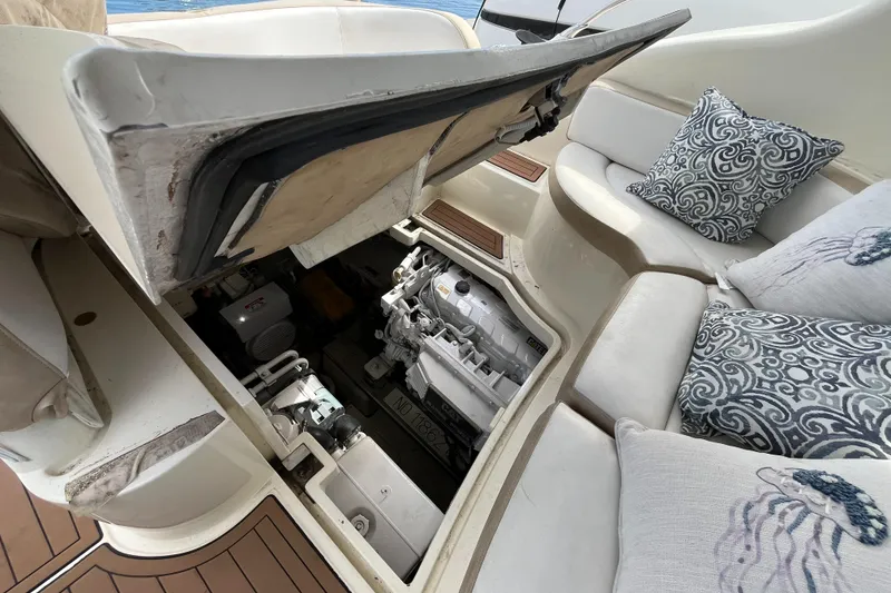 Slide: The Image of 2006 Azimut Atlantis yacht engine compartment with open hatch and cushioned seating. - 41