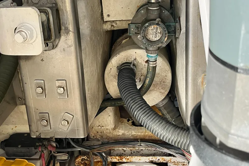 Slide: The Image of Engine compartment of a 2006 Azimut Atlantis yacht, showing mechanical components and hoses. - 46