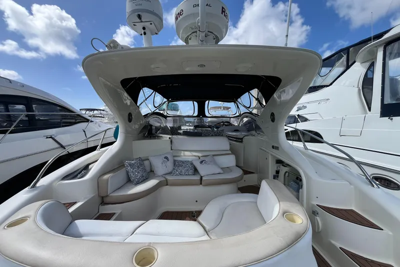 Slide: The Image of 2006 Azimut Atlantis yacht interior with plush seating and modern design under a blue sky. - 5