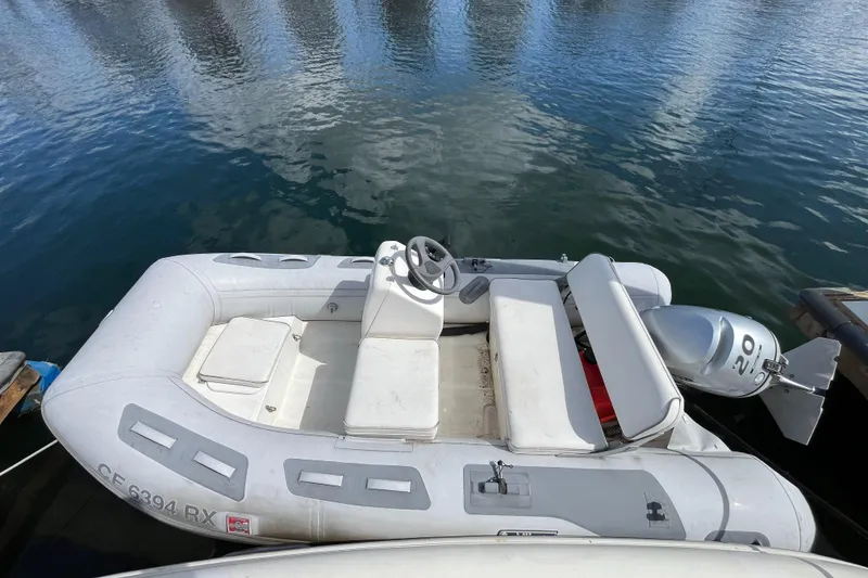 Slide: The Image of Inflatable boat docked on water, featuring a steering wheel and outboard motor. - 7