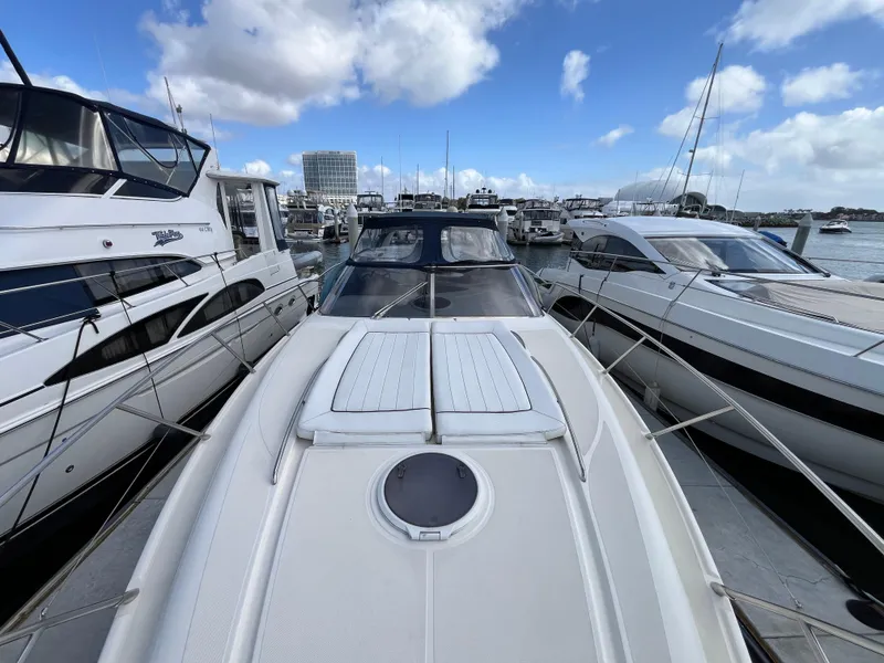Slide: The Image of 2006 Azimut Atlantis yacht docked at a marina under a partly cloudy sky. - 9