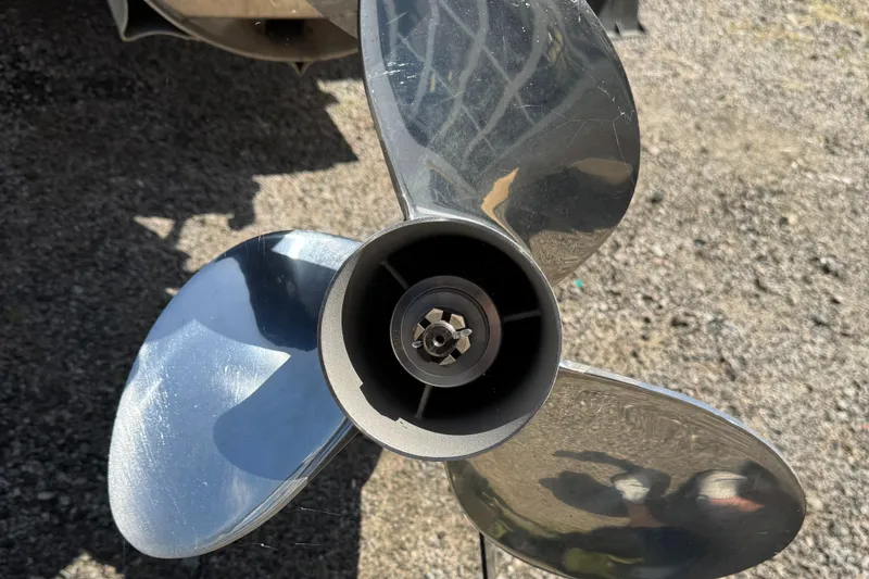 Slide: The Image of 2022 Tahoe Pontoon GT Fish propeller on gravel surface. - 6