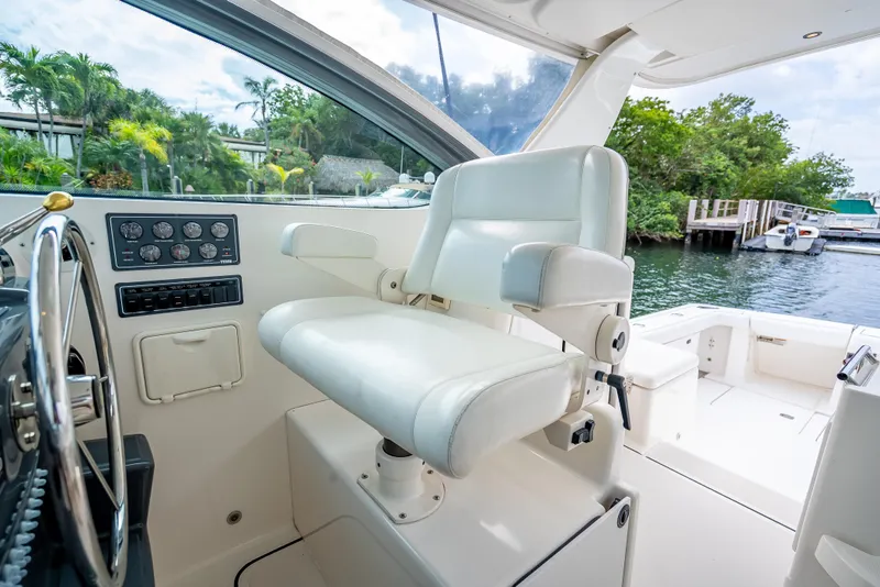 Slide: The Image of Captain's chair on 2005 Tiara Yachts 4200 Open, overlooking serene marina view. - 10