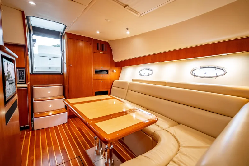 Slide: The Image of 2005 Tiara Yachts 4200 Open interior with elegant wood finish and plush seating. - 11