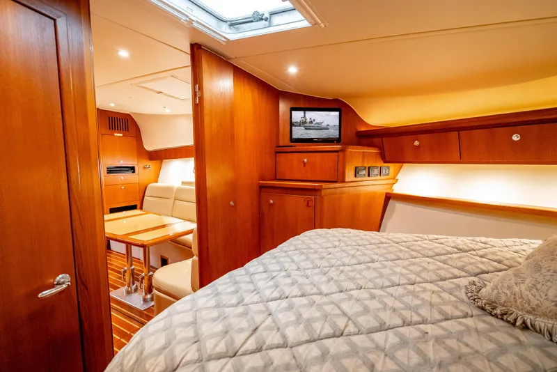 Slide: The Image of Luxurious interior of 2005 Tiara Yachts 4200 Open with cozy bedroom and elegant wood finishes. - 16