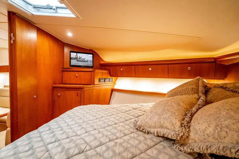 Slide: The Image of Luxurious cabin interior of 2005 Tiara Yachts 4200 Open with cozy bedding and wood finish. - 17