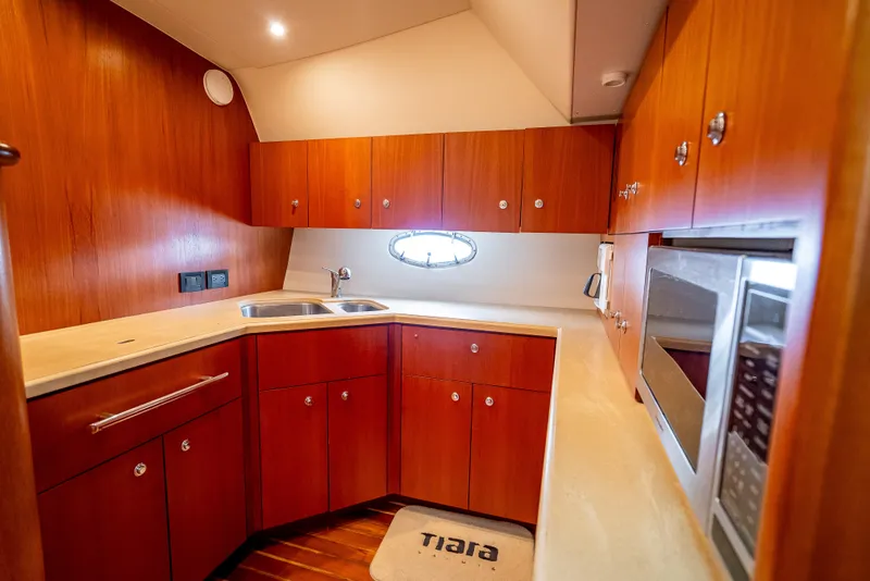 Slide: The Image of 2005 Tiara Yachts 4200 Open kitchen with wood cabinetry and modern appliances. - 19