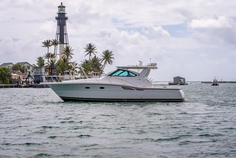 Slide: The Image of 2005 Tiara Yachts 4200 Open cruising near a lighthouse and palm trees. - 2