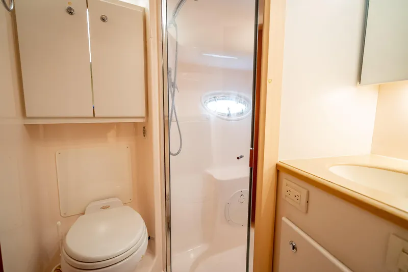 Slide: The Image of 2005 Tiara Yachts 4200 Open bathroom with shower, toilet, and sink. - 21