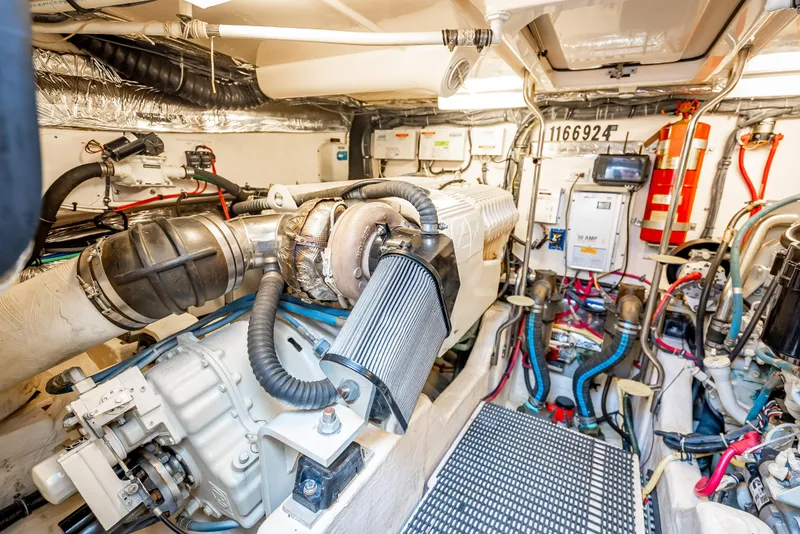 Slide: The Image of Engine room of 2005 Tiara Yachts 4200 Open, showcasing mechanical components and wiring. - 26