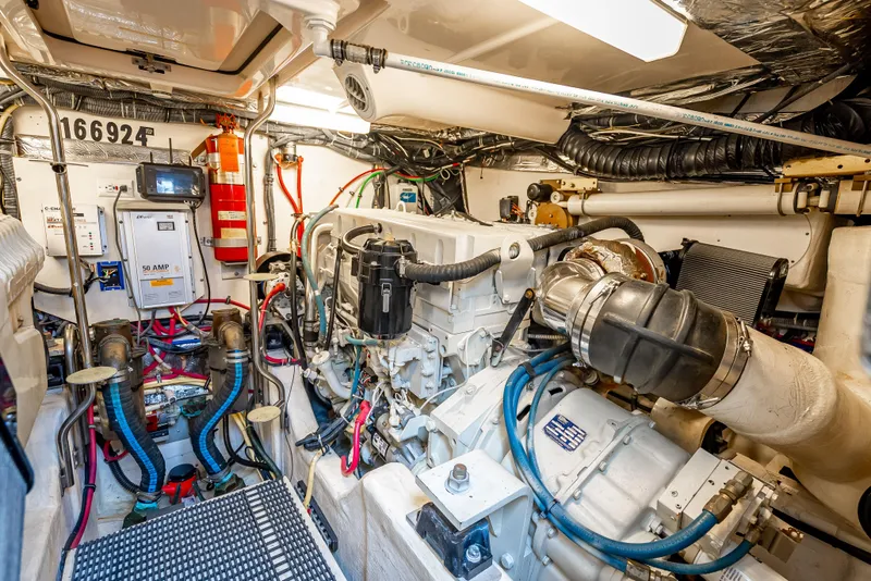 Slide: The Image of Engine room of a 2005 Tiara Yachts 4200 Open, showcasing mechanical components and wiring. - 27