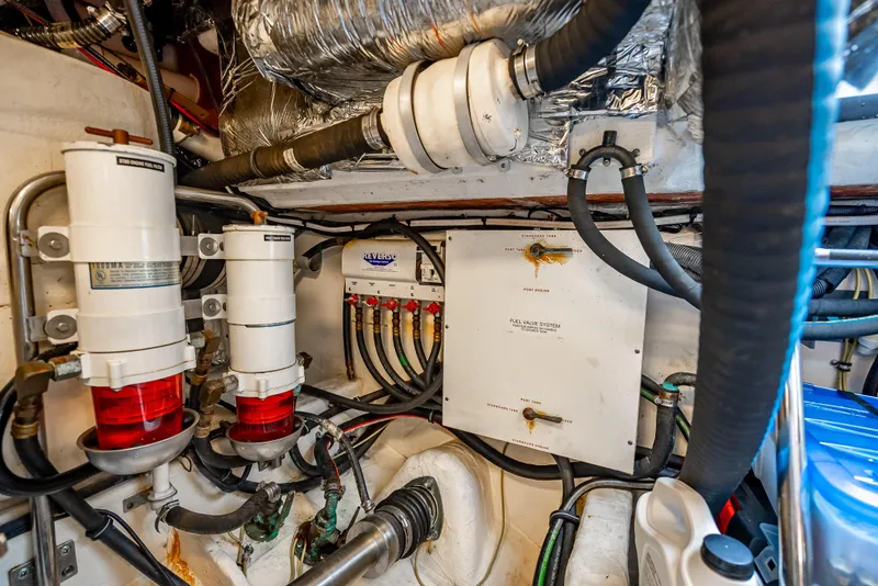 Slide: The Image of Engine room of 2005 Tiara Yachts 4200 Open, showcasing complex wiring and filtration systems. - 30