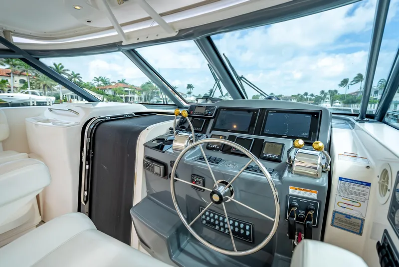 Slide: The Image of 2005 Tiara Yachts 4200 Open helm with modern navigation equipment and luxurious seating. - 34