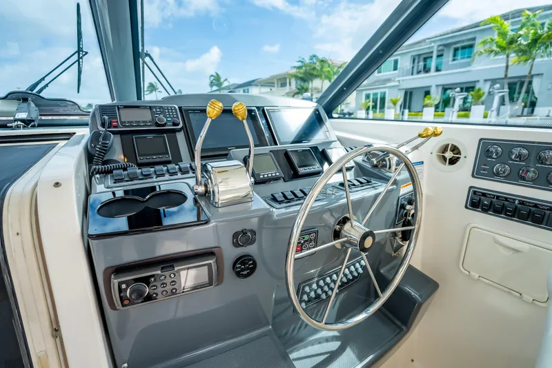 Slide: The Image of Helm of 2005 Tiara Yachts 4200 Open, featuring modern controls and steering wheel. - 35