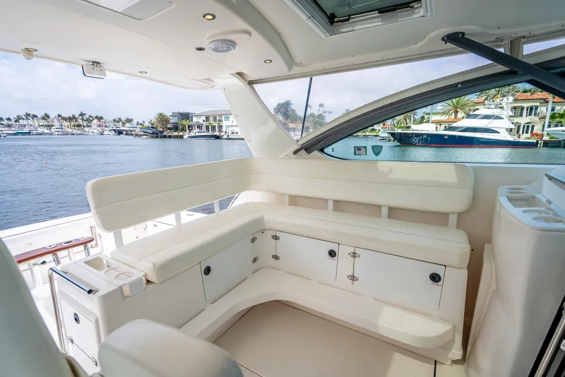 Slide: The Image of 2005 Tiara Yachts 4200 Open interior with white seating and waterfront view. - 36