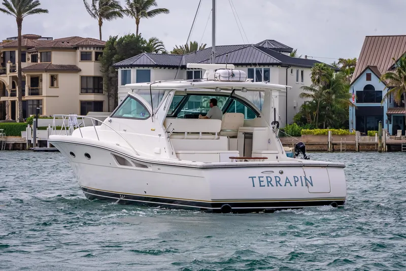Slide: The Image of 2005 Tiara Yachts 4200 Open boat named Terrapin on water near luxury homes. - 4