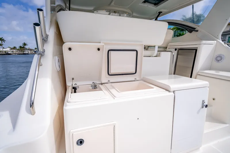 Slide: The Image of 2005 Tiara Yachts 4200 Open interior with sleek white cabinetry and storage compartments. - 41