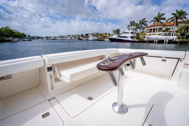 Slide: The Image of 2005 Tiara Yachts 4200 Open deck with rod holders, overlooking a scenic waterfront. - 46