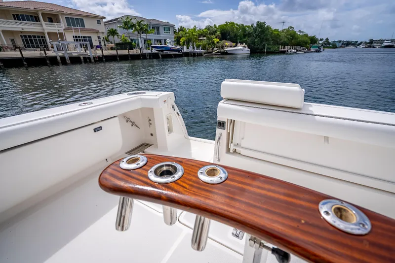 Slide: The Image of 2005 Tiara Yachts 4200 Open boat with rod holders, docked near waterfront homes. - 47