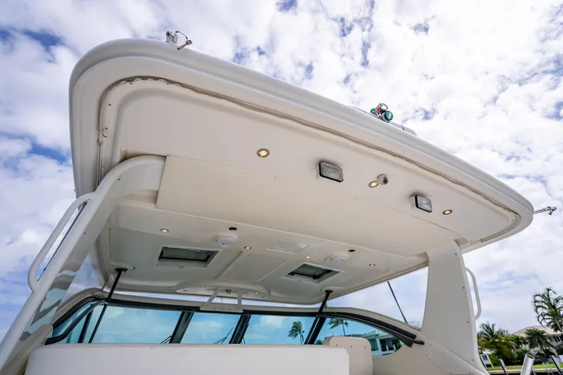 Slide: The Image of 2005 Tiara Yachts 4200 Open boat, showcasing sleek design and modern features under a cloudy sky. - 48