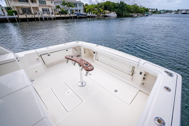 Slide: The Image of 2005 Tiara Yachts 4200 Open cockpit with waterfront view, featuring sleek design and fishing rod holders. - 50