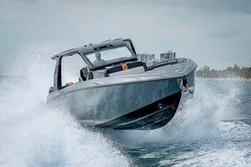 Slide: The Image of 2023 Cigarette 41 Nighthawk speedboat cutting through waves, showcasing sleek design and power. - 4