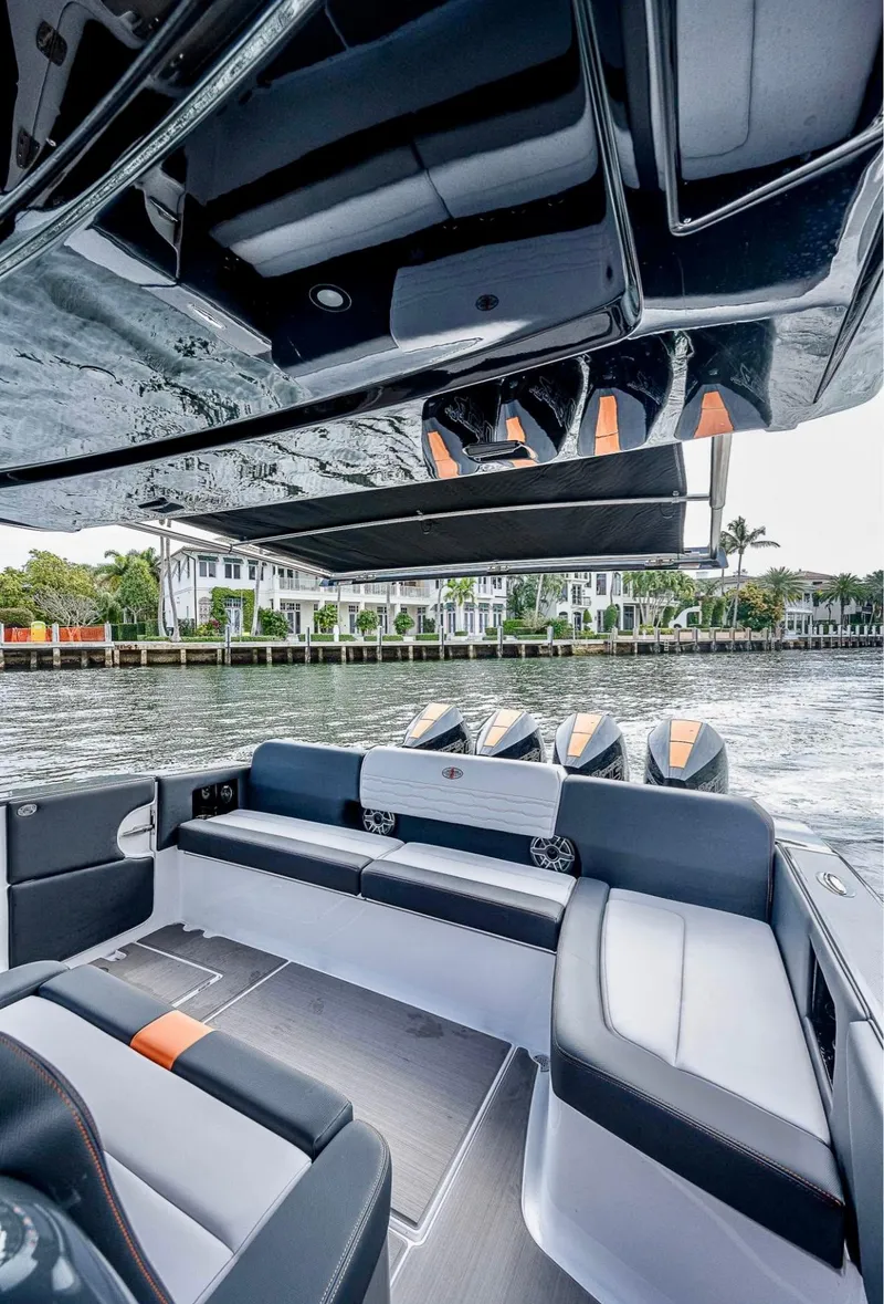 Slide: The Image of 2023 Cigarette 41 Nighthawk boat interior with sleek seating and modern design on the water. - 7